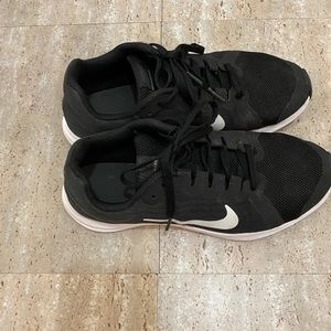 Kids Black and White Nike Sneakers.